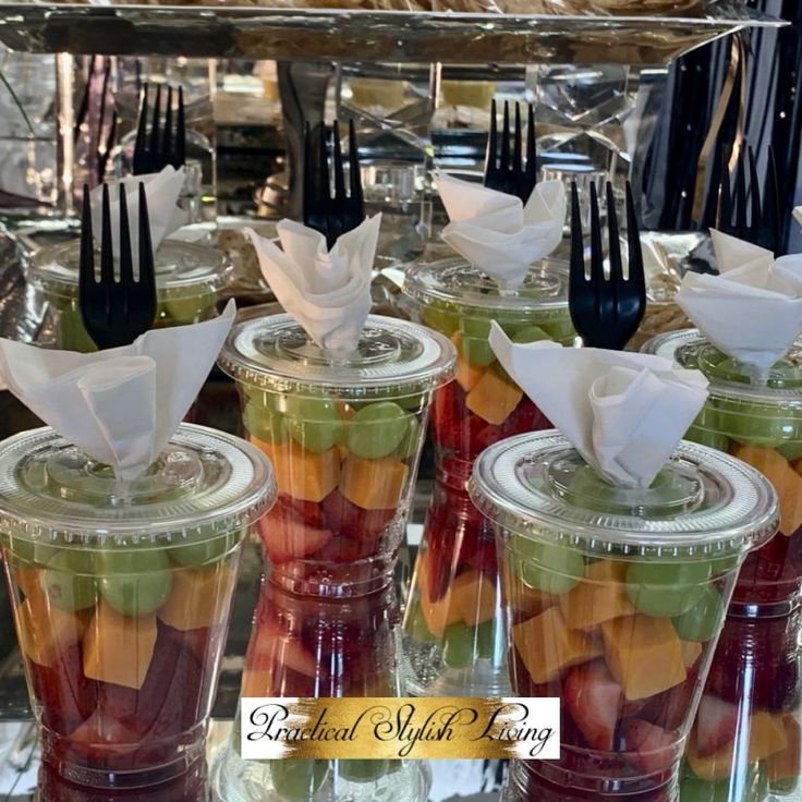 there are many different types of fruit in plastic cups with forks on the top and bottom