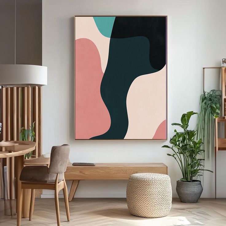 an abstract painting hangs on the wall above a wooden table in a modern living room