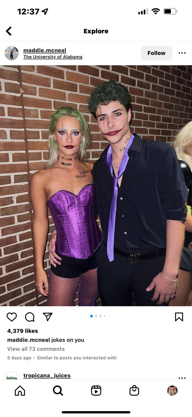 two people dressed in costumes standing next to each other and one is wearing a purple corset