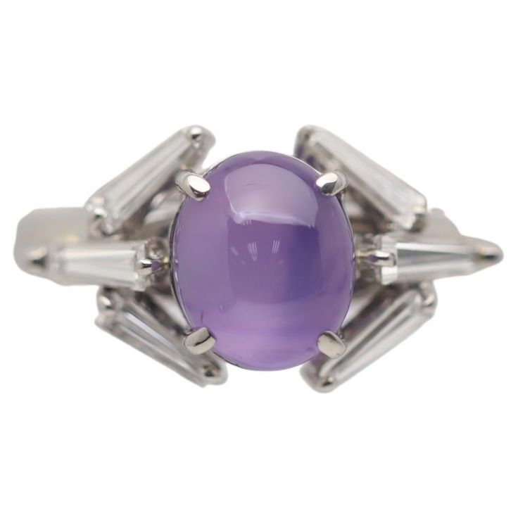 A chic and stylish geometric ring featuring a 3.87 carat star sapphire with a clean rich purple color. The sapphire has excellent clarity along with a strong 6-rayed star making the stone a true gem. It is complemented by 6 baguette-cut diamonds which are set around the sapphire in a unique geometric pattern and weigh a total of 0.57 carats. Hand-fabricated in platinum and ready to be worn. Ring Size 6.25 Weight: 9.2 grams Star Sapphire Ring, Purple Star, Platinum Diamond Rings, Pink Star, Rich Purple, Star Sapphire, Geometric Ring, Baguette Cut Diamond, Platinum Ring