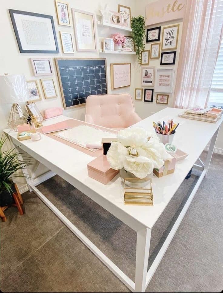 a white desk topped with lots of pink and gold items next to a window filled with framed pictures