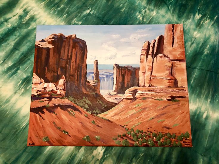 a painting of some rocks in the desert