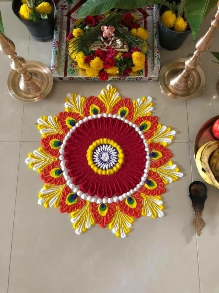 a decorated floor with flowers, candles and other items on the ground in front of it