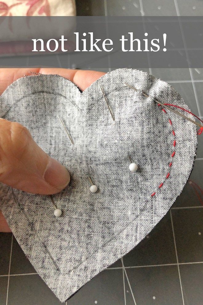 someone is making a heart out of fabric and pins on the sewing machine with text overlay that reads, not like this