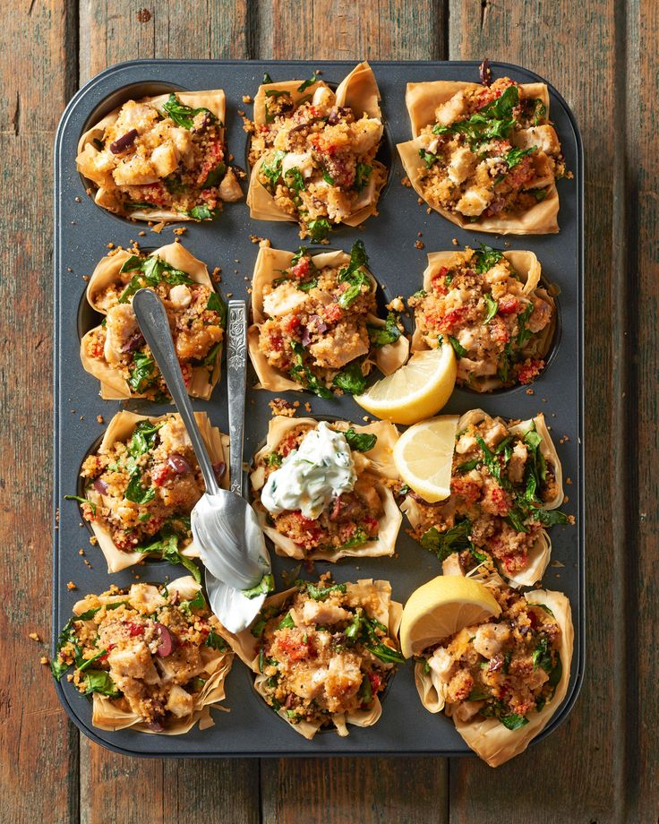 a tray filled with different types of appetizers on top of a wooden table