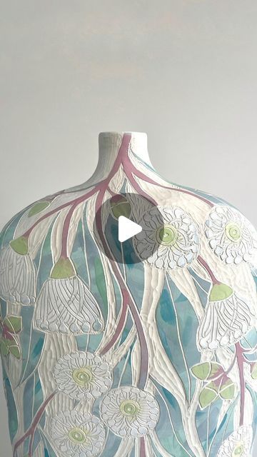 an artistic vase with flowers painted on it