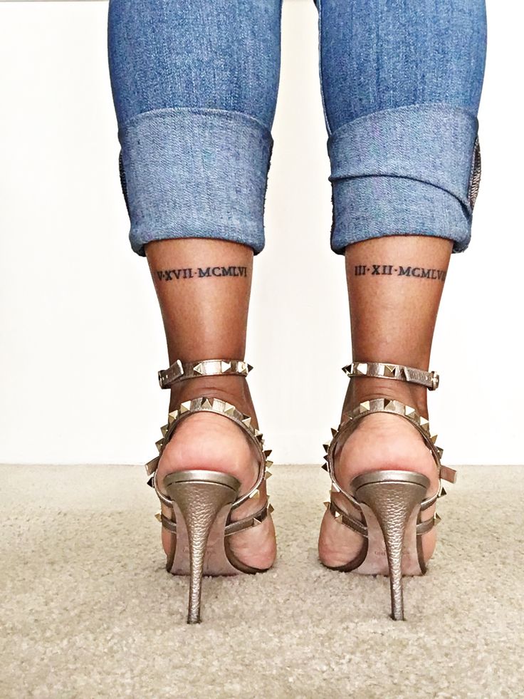 the legs and ankles of a woman wearing high heeled shoes with spikes on them