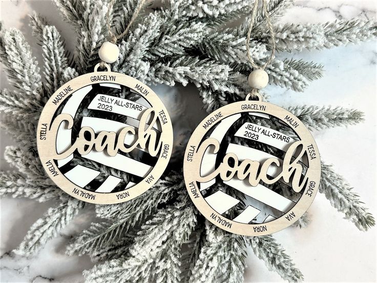 two christmas ornaments with the words coach on them