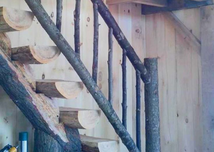 a wooden staircase made out of logs and branches