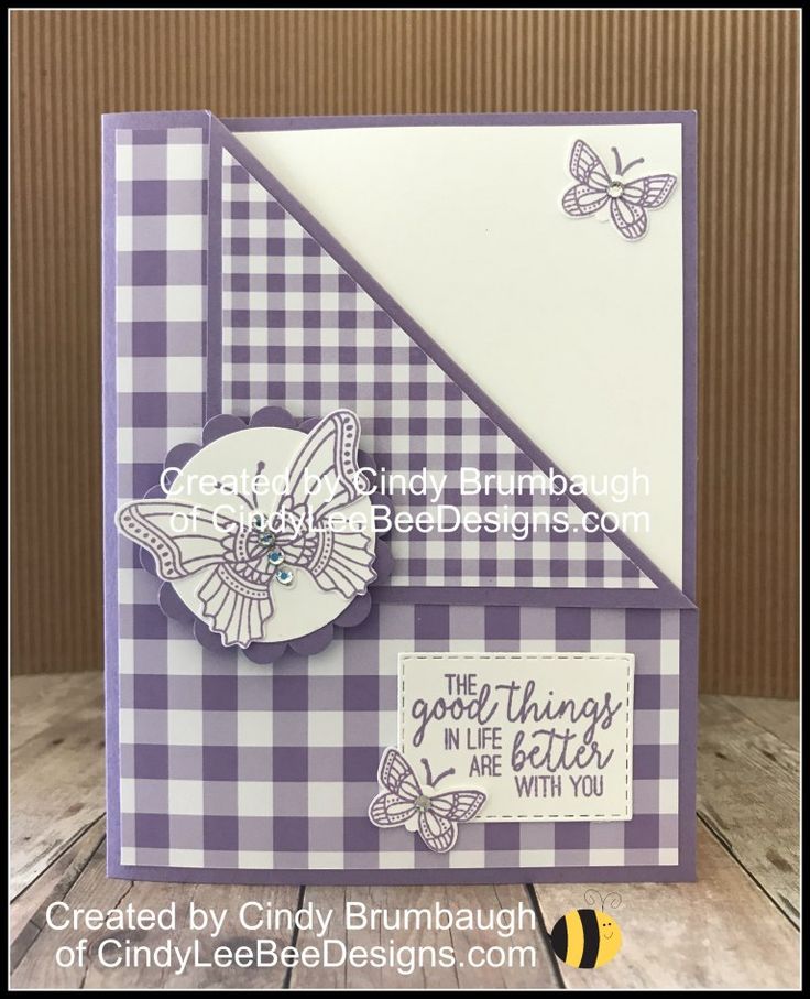 a close up of a card with a butterfly and checkerboard pattern on it