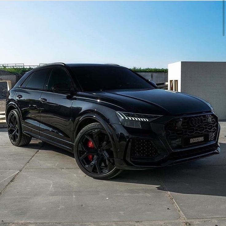 a black suv parked in front of a building