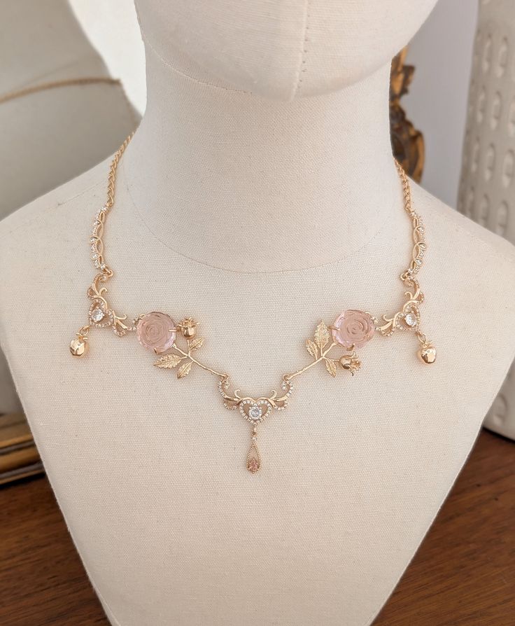 Beautifully Enchanting necklace adorned with whimsical pink roses, gold apples and crystal hearts.  A truly unique piece of jewelry to cherish for years to come.  DETAILS *Handmade in my small boutique studio. *The chain is gold filled. *Necklace measures 16" with 2" extension chain (Please message me if you with for the chain length to be extended or made shorter)  *Your necklace will arrive securely in a necklace jewelry box. Please use this box when not wearing your necklace to avoid it getti Aphrodite Necklace, Fairycore Necklace, Necklace Royal, Pink Gold Necklace, Fantasy Crown, Boutique Studio, Pink Victorian, Princess Necklace, Gold Apple