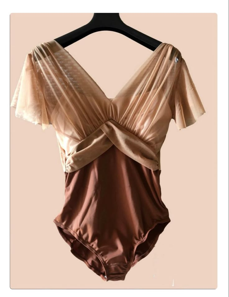 a brown swimsuit hanging on a hanger