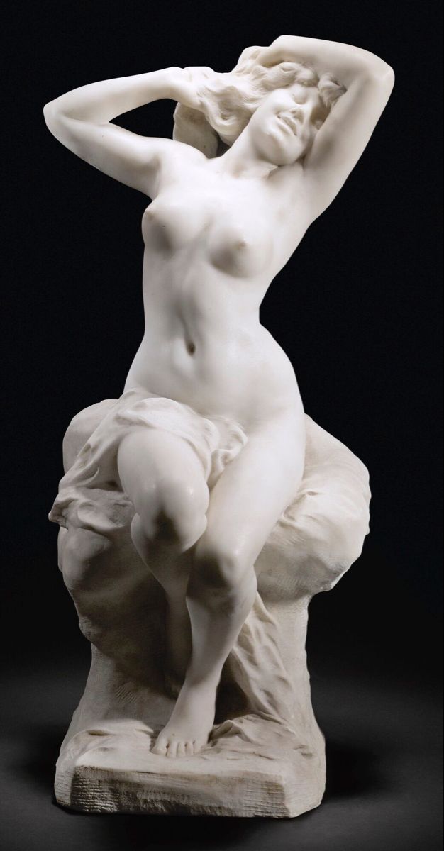 a statue of a woman sitting on top of a white marble base with her hands behind her head