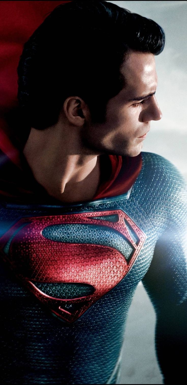 a man in a superman suit with his hands on his hips and looking off to the side