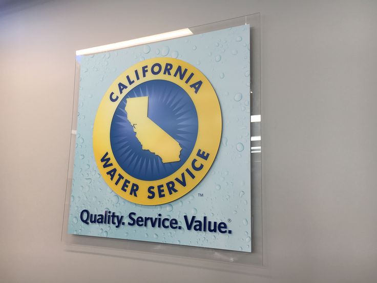 the california water service sign is hanging on the wall next to it's logo