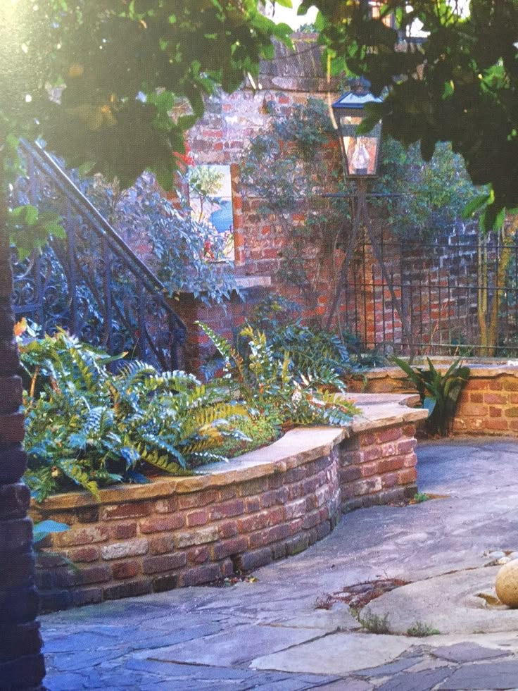 an outdoor garden with brick walls and plants