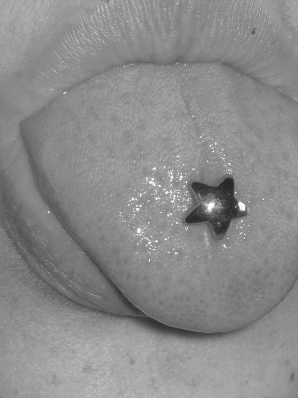 a black and white photo of a person's lip with a star on it