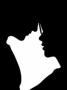 the silhouette of a woman's head with her hands on her chin, against a black background