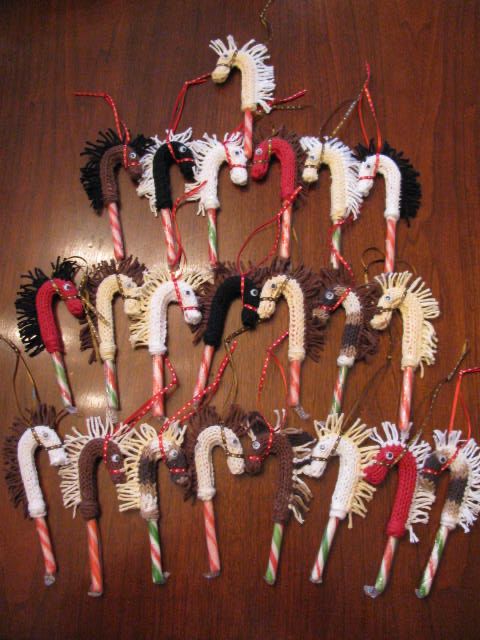 several christmas candy canes are arranged in the shape of horses on a wooden table