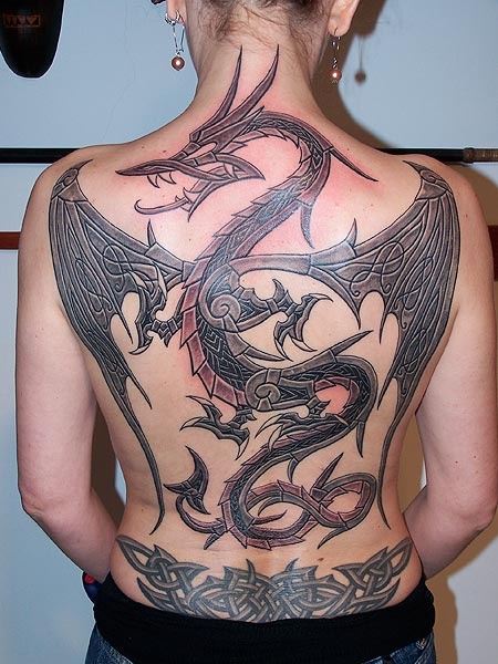 a woman with a dragon tattoo on her back