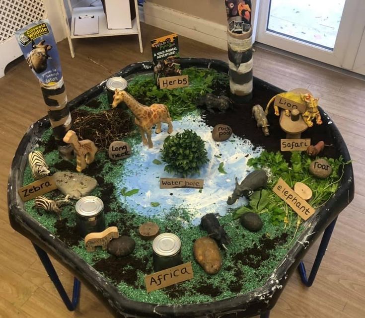 a table that has some plants and animals on it