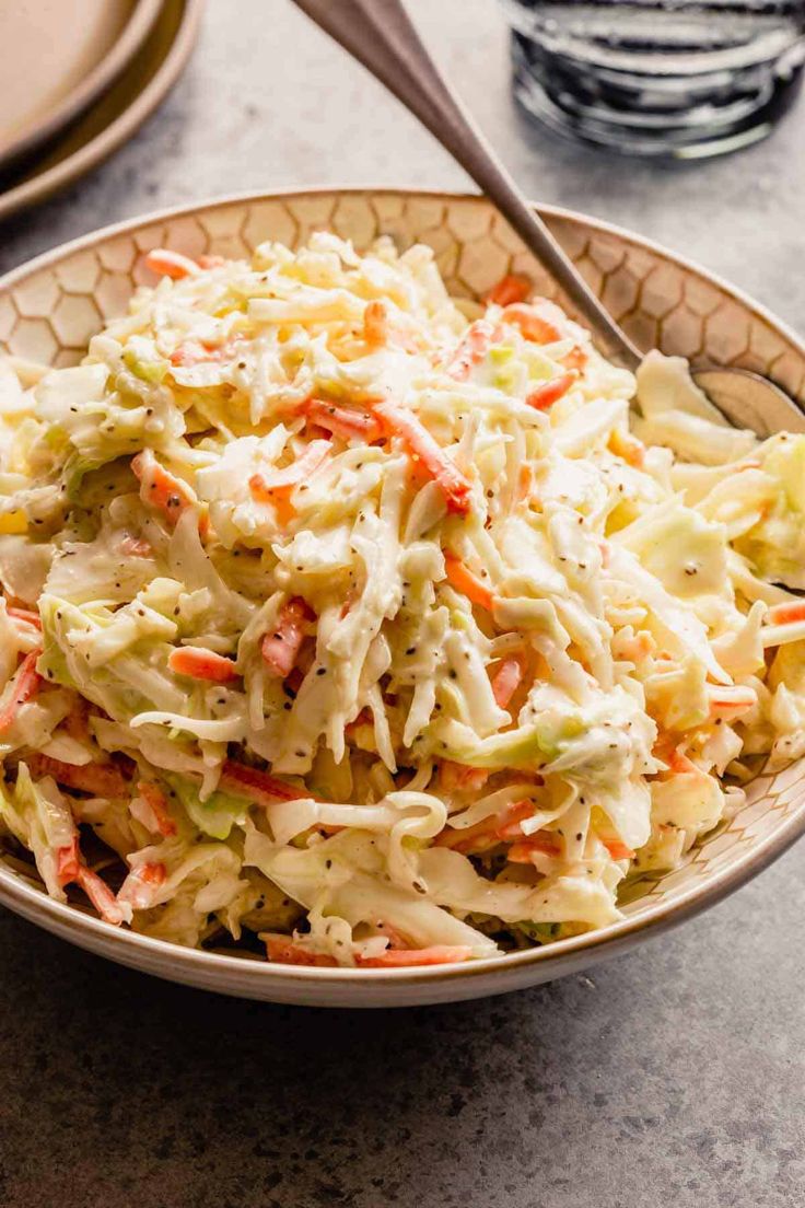 a bowl filled with coleslaw and carrots