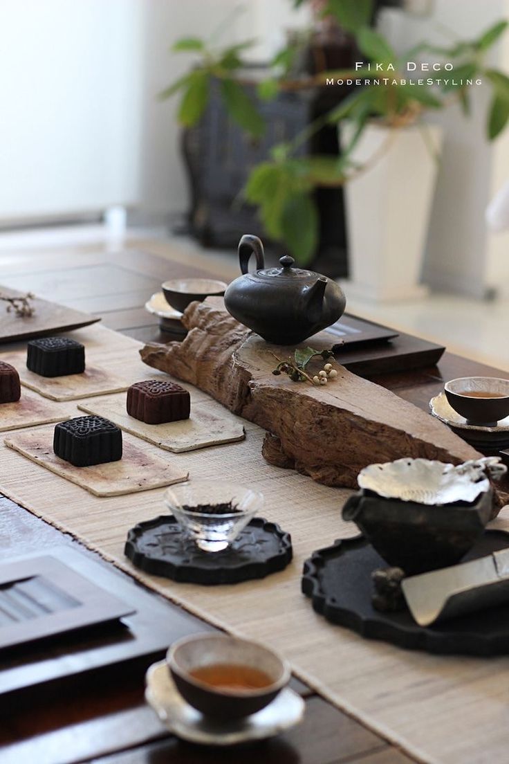 a table topped with lots of different types of tea cups and saucers next to each other