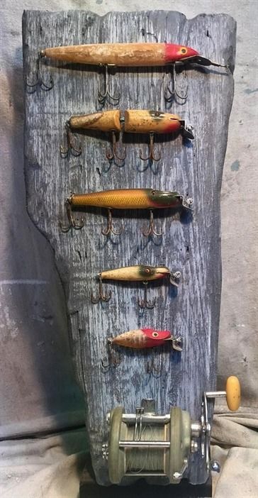 an assortment of fishing lures hanging on a wall