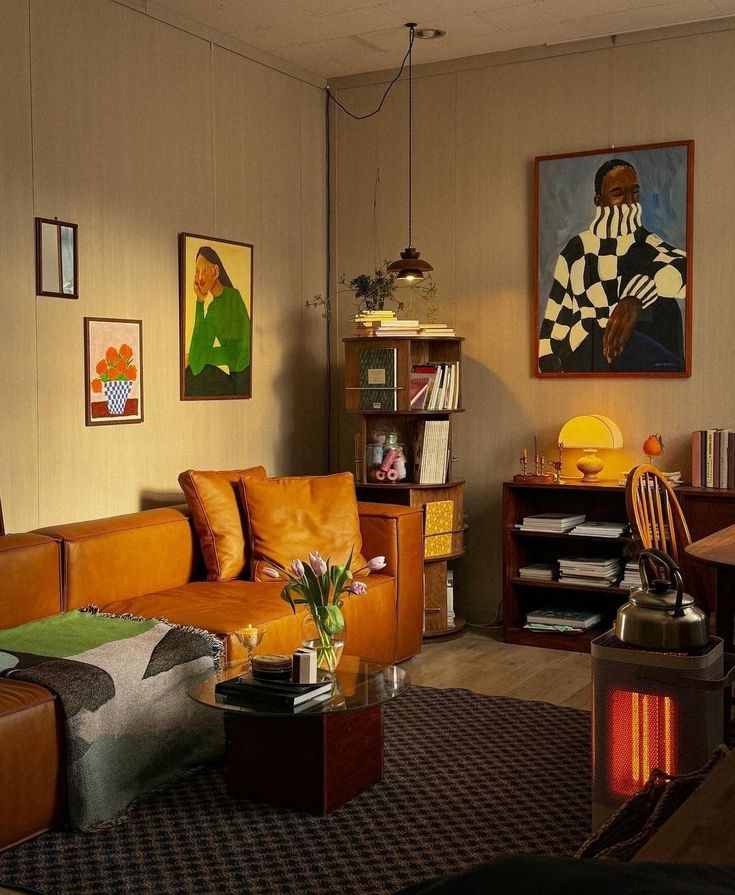 a living room filled with furniture and pictures on the wall