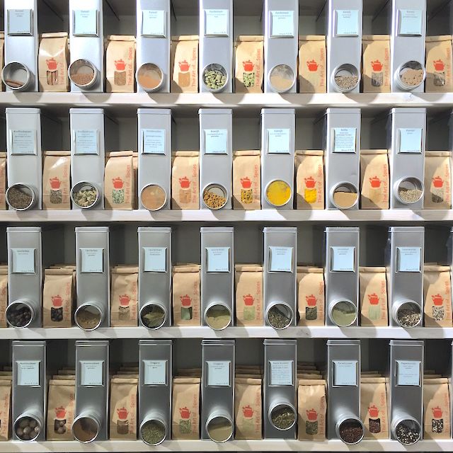 the shelves are filled with different types of spices