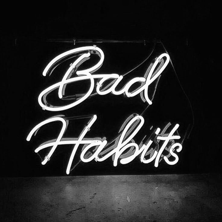 a neon sign that says bad habitts in white letters on a black background with the word bad habitts written below it