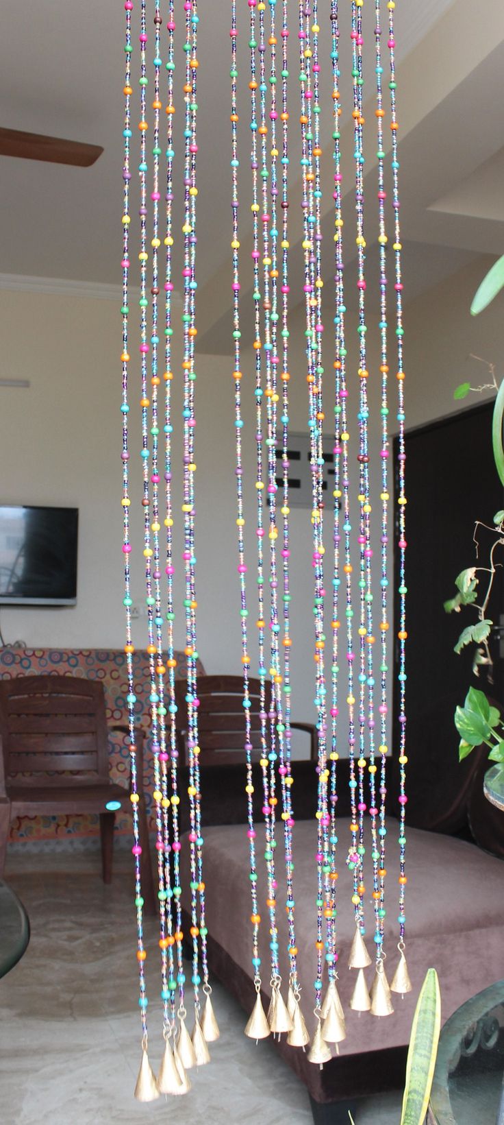 multicolored beads hanging from the ceiling in a living room