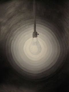 a light bulb hanging from the ceiling in a dark room