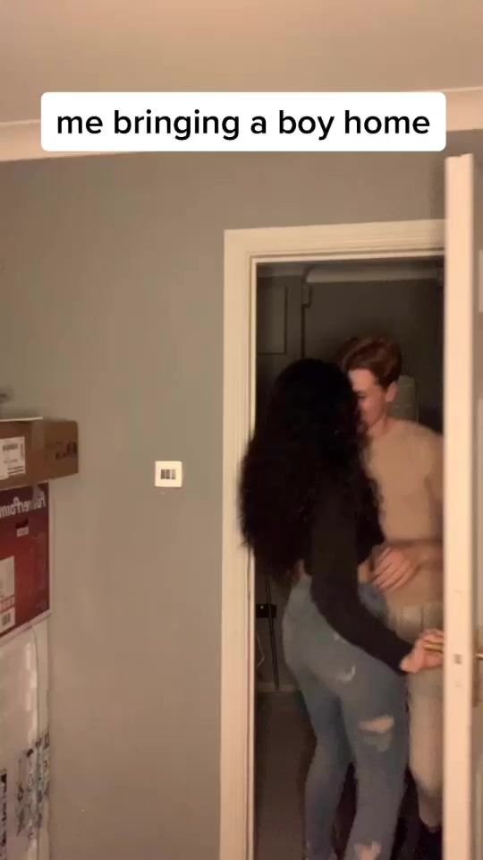 two people hugging each other in front of a door with the caption me bringing a boy home