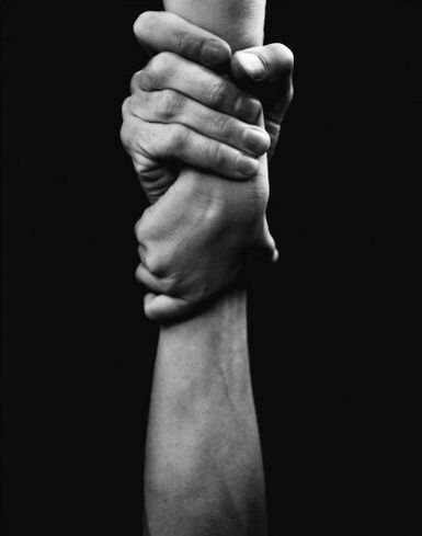 two hands holding each other in black and white