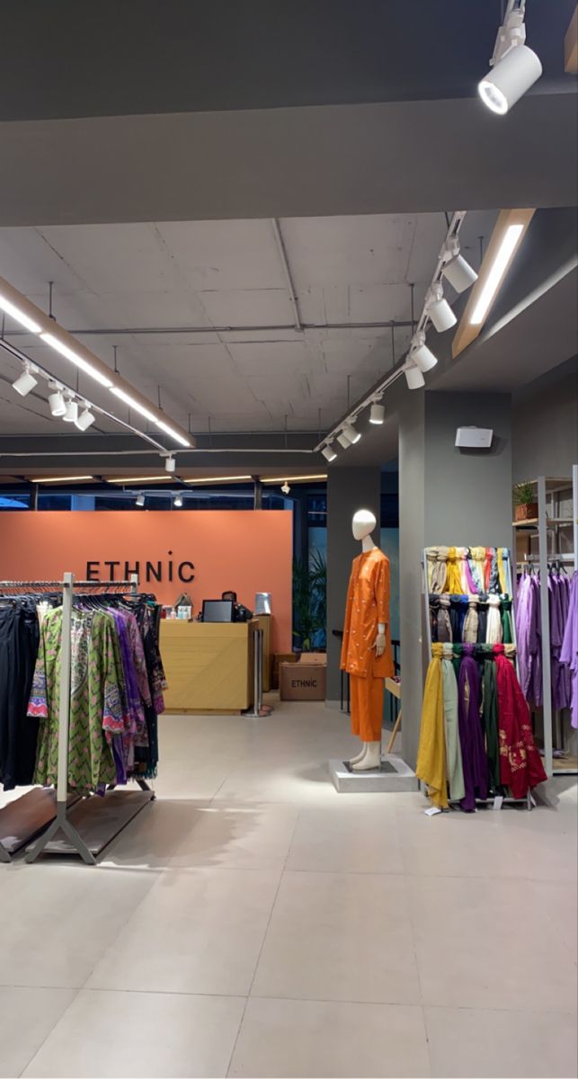 an empty clothing store with clothes on display