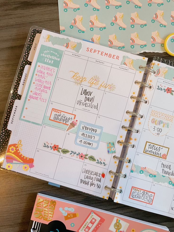 an open planner book sitting on top of a wooden table