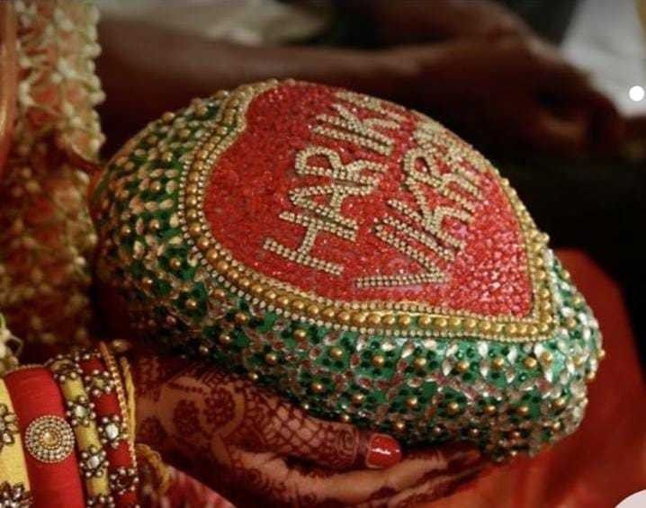 a red and green hat sitting on top of a table next to other jewelry items