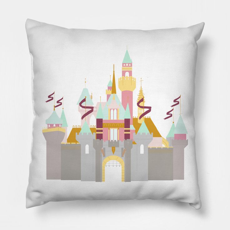 a white pillow with a castle on it's side and the words disney written in pink