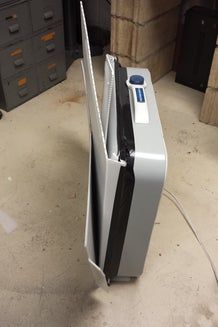 a refrigerator sitting on the ground in a garage