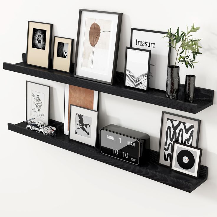 some black shelves with pictures and frames on them