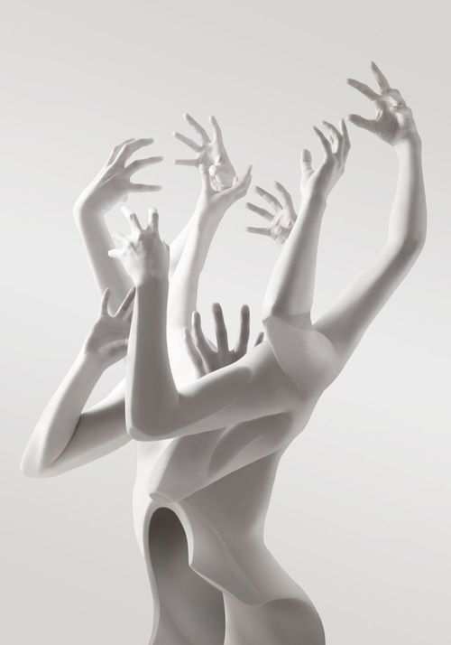 two women in white bodysuits reaching up to reach for something with their hands