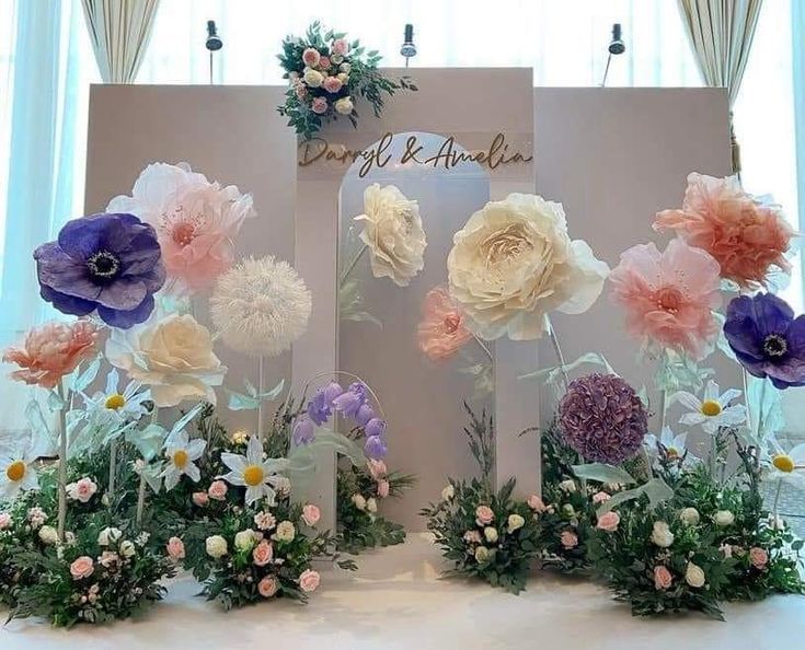 an arrangement of flowers on display in front of a sign