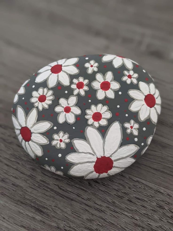 a painted rock sitting on top of a wooden table