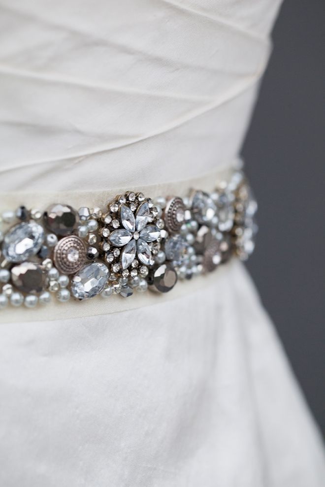 a bridal belt is adorned with crystal stones, pearls and other jeweled accessories