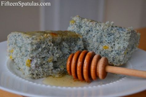 a white plate topped with two pieces of food and a wooden stick on top of it