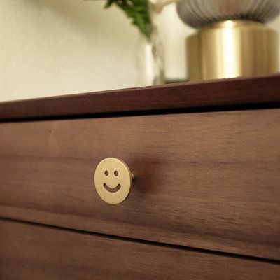 a close up of a drawer with a smiley face on it