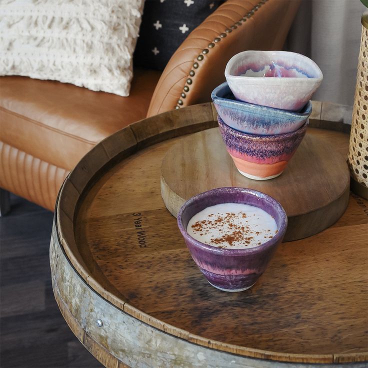 three bowls are sitting on a wooden table