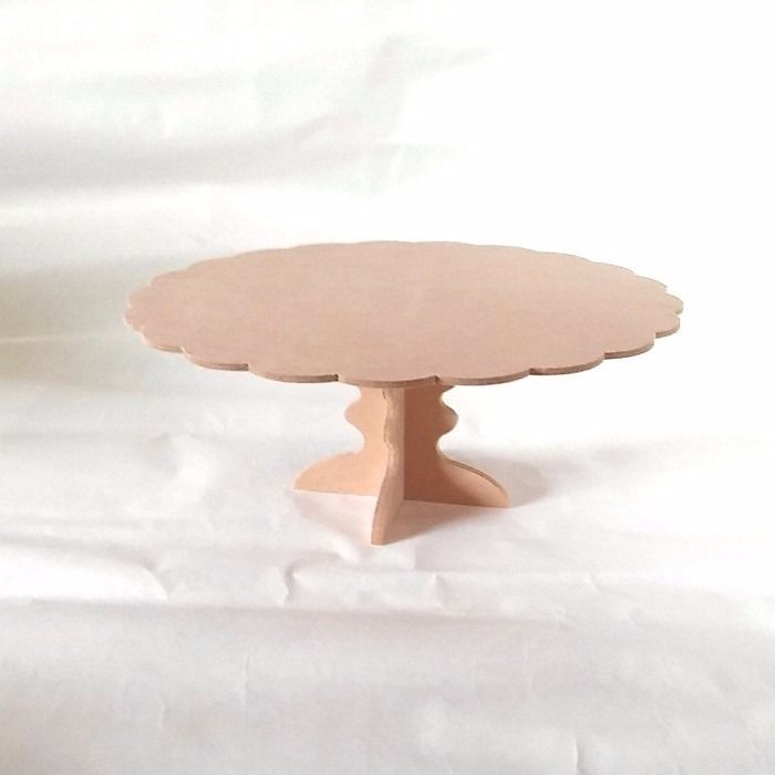 a small wooden table sitting on top of a white sheet